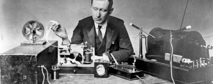 A black and white image of a man recording a voiceover